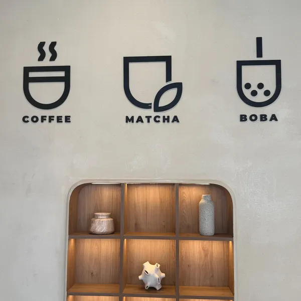 Coffee, matcha and boba icons on the wall at CUPP Hyderabad